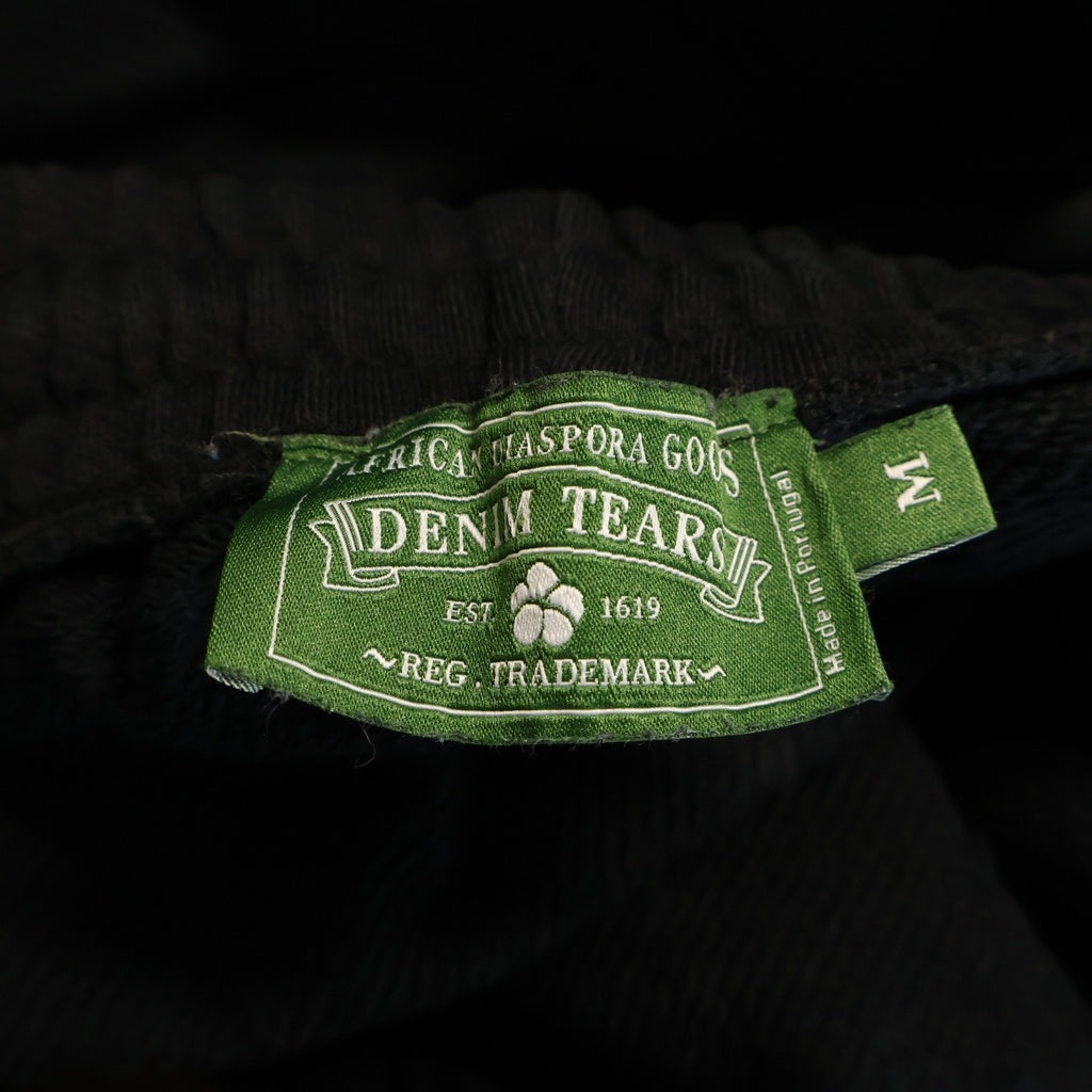 DENIM TEARS(デニムティアーズ) MONO COTTON WREATH SWEAT PANTS モノコットン フラワーモチーフ スウェットパンツ ブラック
