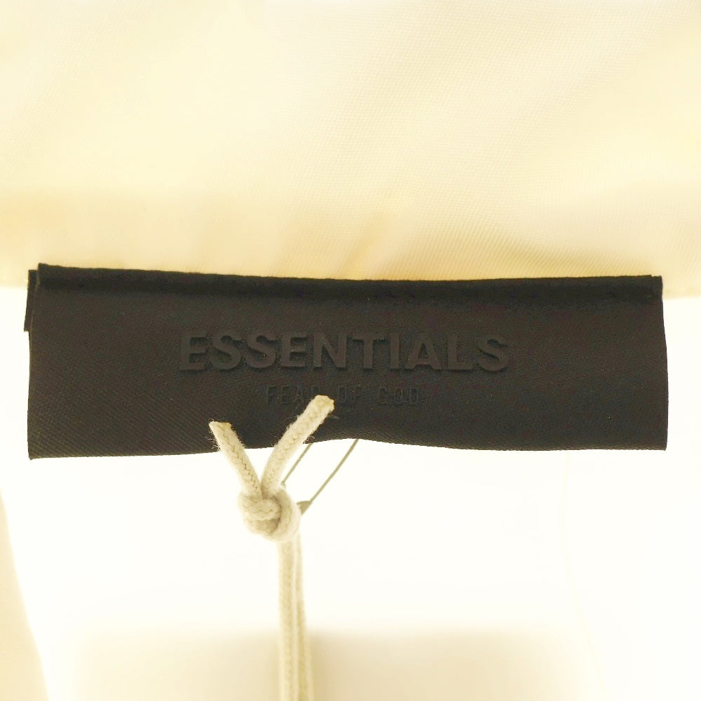 FEAR OF GOD ESSENTIALS(フィアオブゴッド エッセンシャルズ) NYLON COACH JACKET バックラバーロゴ ナイロンコーチジャケット アイボリー