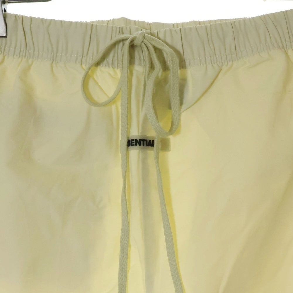 FEAR OF GOD ESSENTIALS(フィアオブゴッド エッセンシャルズ) NYLON PANTS リフレクターロゴ ナイロンパンツ アイボリー