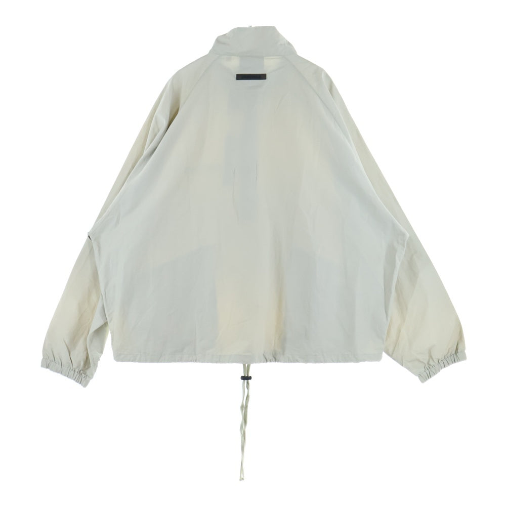 FEAR OF GOD ESSENTIALS(フィアオブゴッド エッセンシャルズ) HALF ZIP NYLON JACKET リフレクターロゴ ハーフジップ ナイロンジャケット ベージュ
