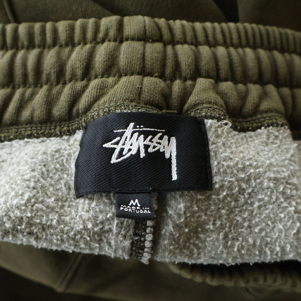 STUSSY(ステューシー) Fleece Pant Faded Graphic フェード加工 ロゴプリント フリース スウェットパンツ ブラウン 116667
