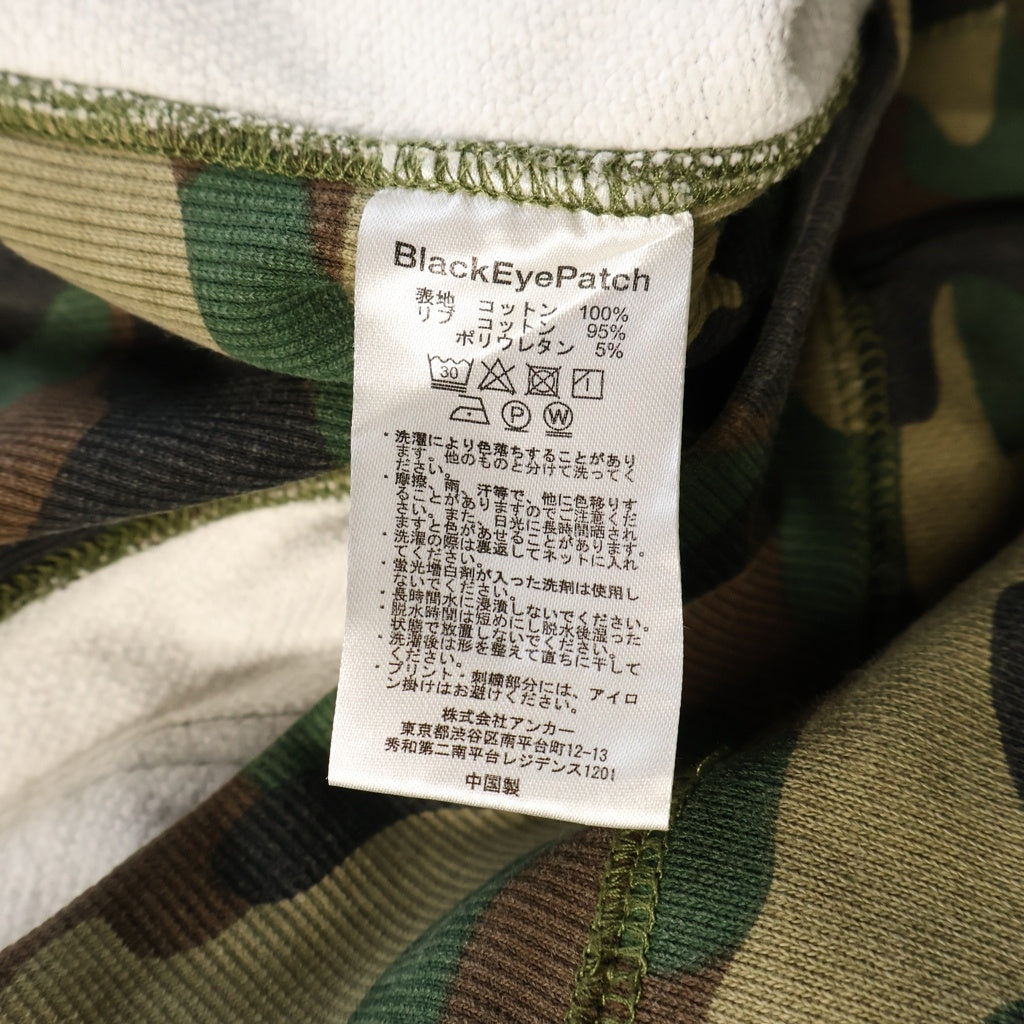 THE BLACK EYE PATCH(ブラックアイパッチ) Camouflage HWC Label Hoodie カモフラージュ総柄 フロント取扱注意ロゴ 刺繍 プルオーバー パーカーフーディー カーキ