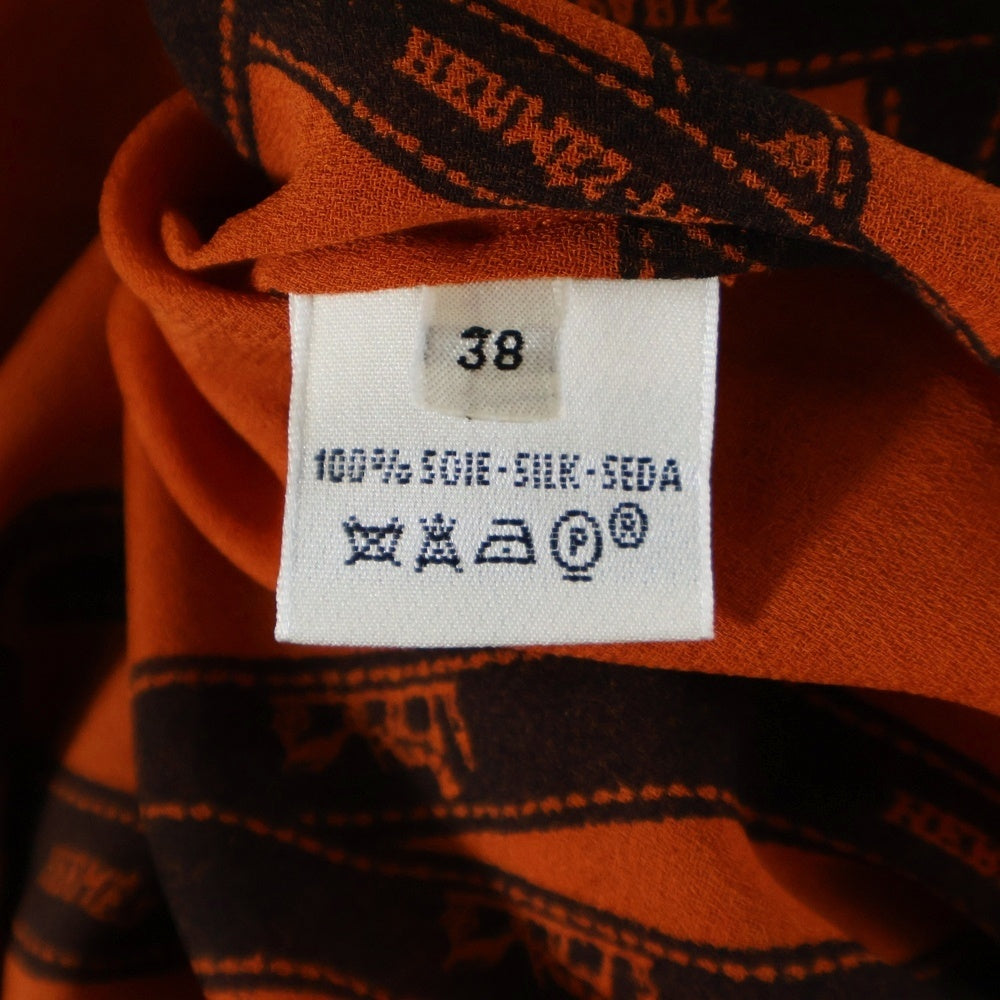 HERMES(エルメス) ボリュデュック リボン総柄 ロゴプリント シルク クルーネック 長袖シャツ ブラウス オレンジ レディース