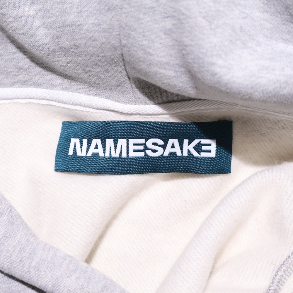 NAMESAKE(ナメサケ) 23AW IVY SLEEVELESS HOODIE フロントプリント スウェットニット切替デザイン スリーブレスプルオーバーパーカー フーディー グレー/ベージュ