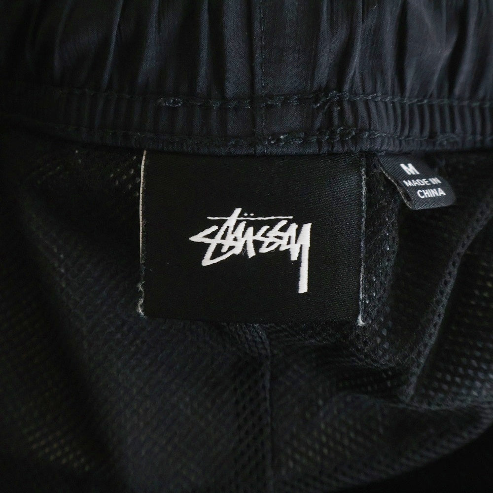 STUSSY(ステューシー) フロントロゴデザイン マルチポケット ドローストリング ナイロンパンツ ブラック