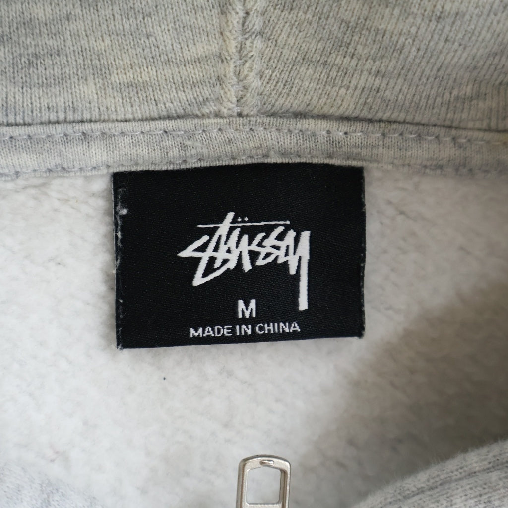 STUSSY(ステューシー) WORLD TOUR ZIP UP HOODIE ワールドツアー ジップアップ フーデッド パーカー グレー