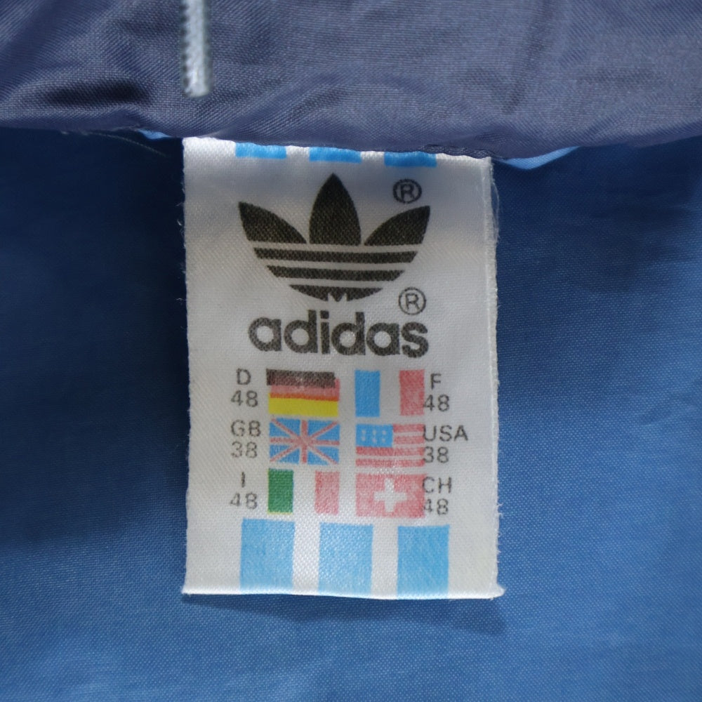 adidas Originals(アディダスオリジナルス) 80S VINTAGE ヴィンテージ 万国旗タグ トレフォイルロゴプリント ジップアップ フーデッドナイロンジャケット ブルー/ネイビー