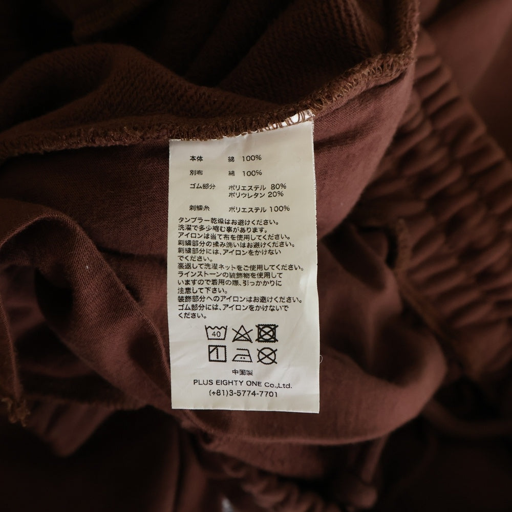 UNKNOWN LONDON(アンノーンロンドン) クロスモチーフ ラインストーン スウェットパンツ ブラウン