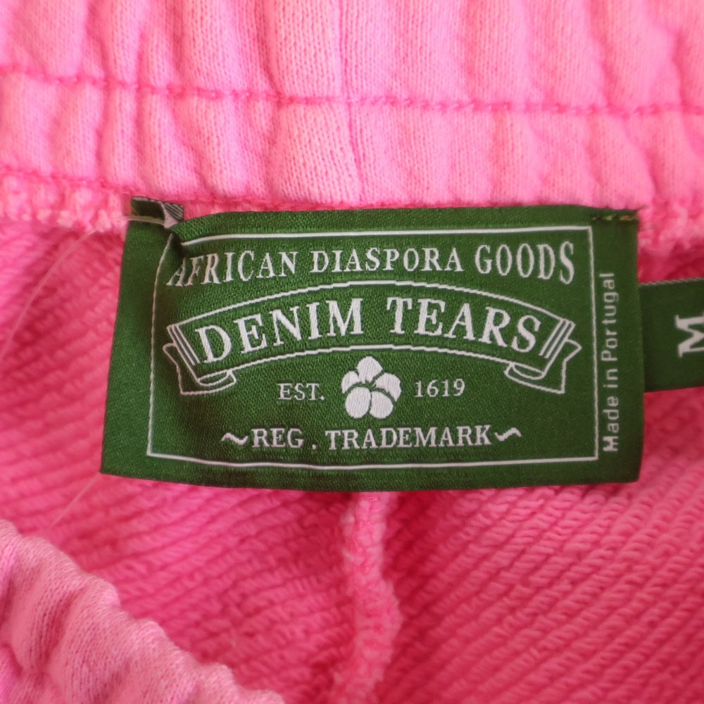 DENIM TEARS(デニムティアーズ) Mono Wreath Sweatpants リースプリント スウェットパンツ ピンク