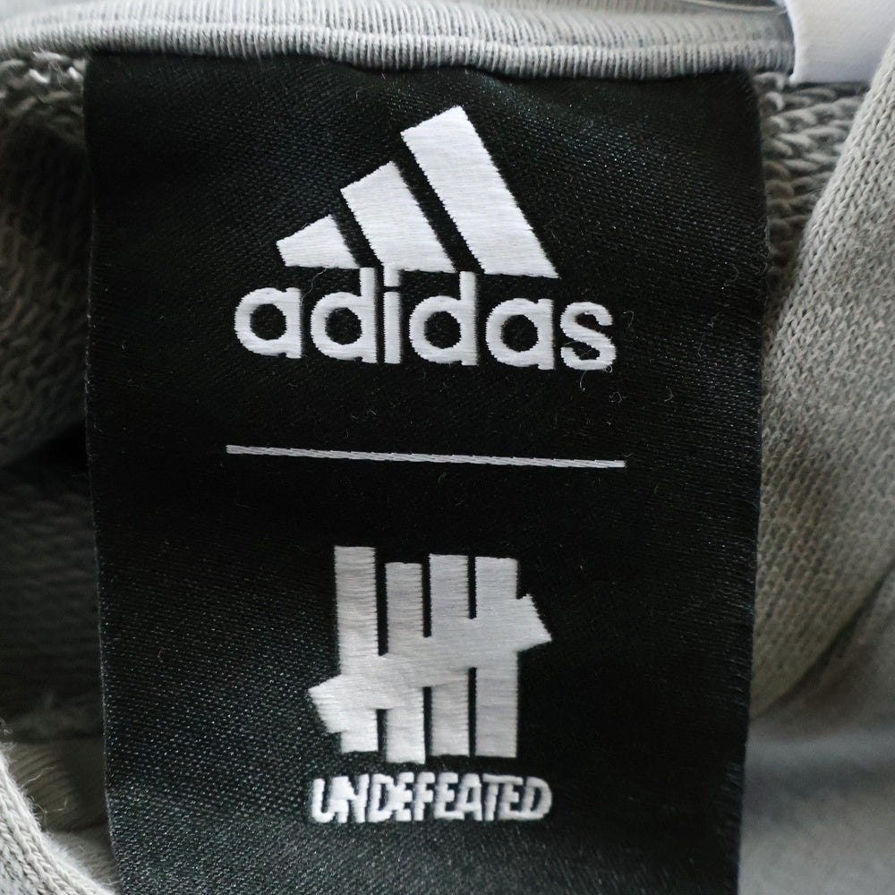 adidas(アディダス) × UNDEFEATED アンディフィーテッド プリントデザイン プルオーバーパーカー フーディー グレー DN8782