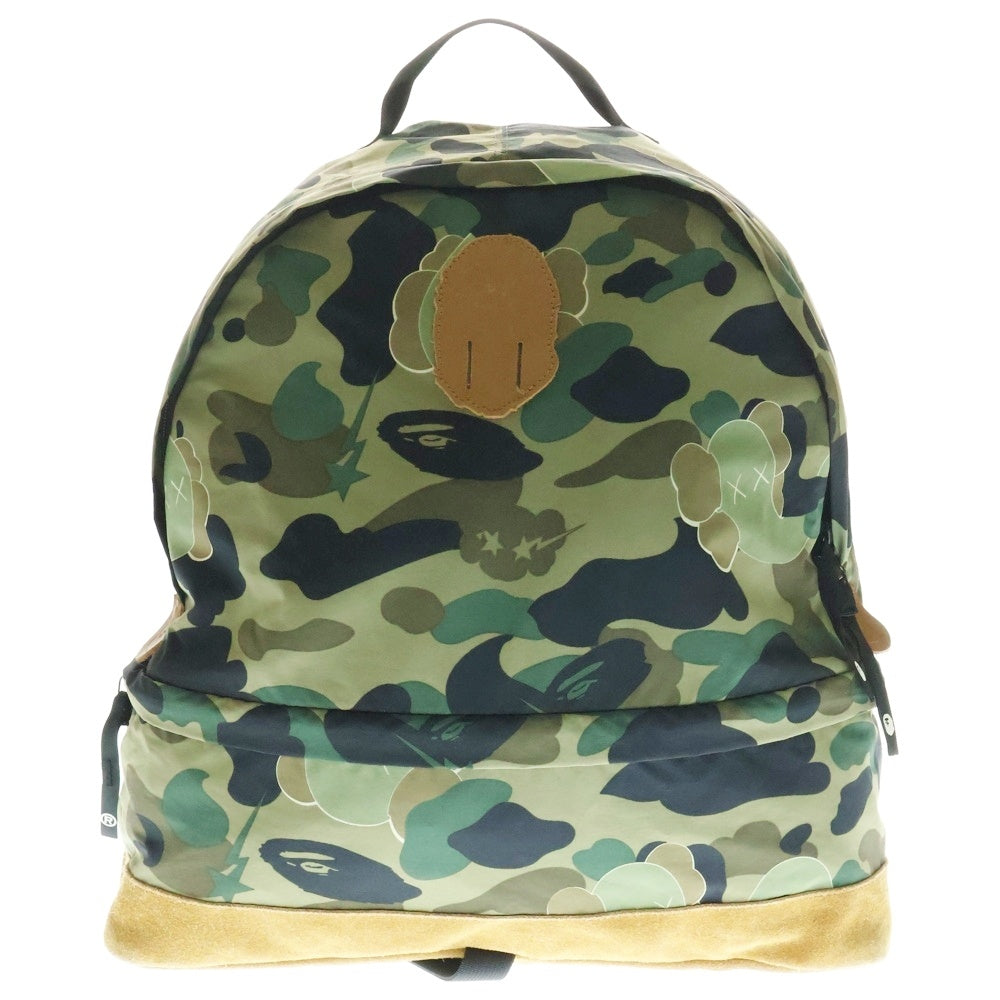 A BATHING APE(アベイシングエイプ) ×KAWS bendy 1st camo green APE HEAD backpack ×カウズ ベンディー ファーストカモエイプヘッド総柄バックパックリュック グリーン