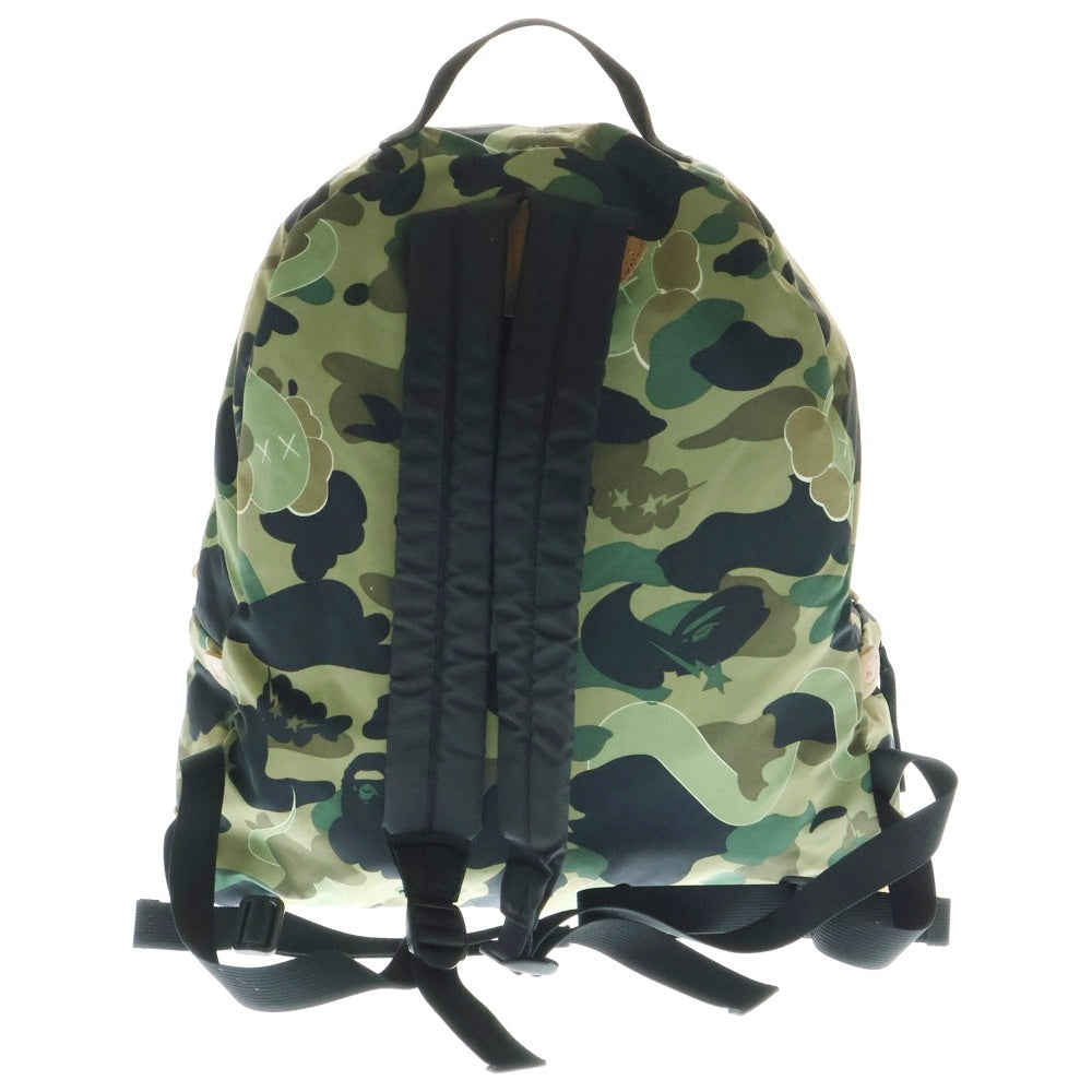 A BATHING APE(アベイシングエイプ) ×KAWS bendy 1st camo green APE HEAD backpack ×カウズ ベンディー ファーストカモエイプヘッド総柄バックパックリュック グリーン
