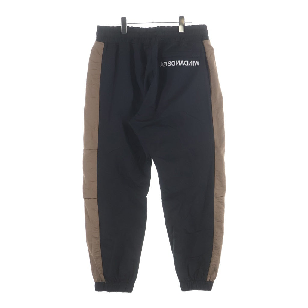 WIND AND SEA(ウィンダンシー) SWEAT TRUCK PANTS ロゴ刺繍 ナイロン トラックパンツ ブラックブラウン WDS-20A-PT-02