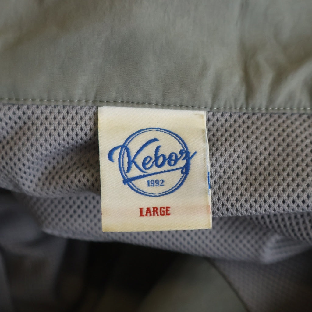 KEBOZ(ケボズ) 2TONE TRACK JACKET ロゴ刺繍 ツートーン ジップアップ ナイロン トラックジャケット グレー/オレンジ