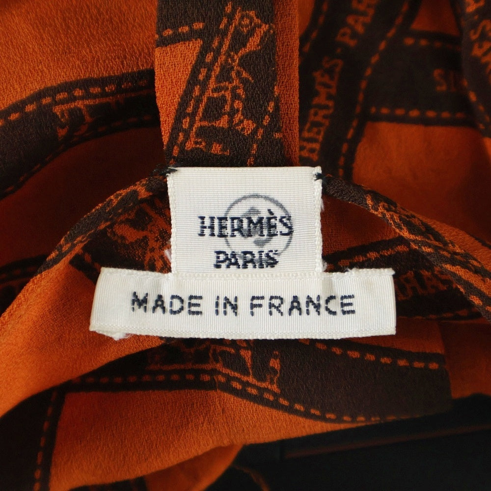HERMES(エルメス) ボリュデュック リボン総柄 ロゴプリント シルク クルーネック 長袖シャツ ブラウス オレンジ レディース
