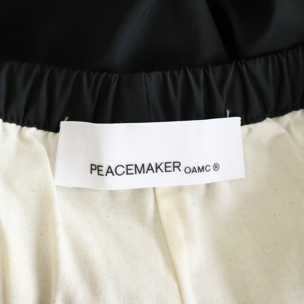 OAMC(オーエーエムシー) PEACEMAKER ピースメーカー 裾ドローコード付き ナイロントラウザー パンツ ブラック 1214-3-000001