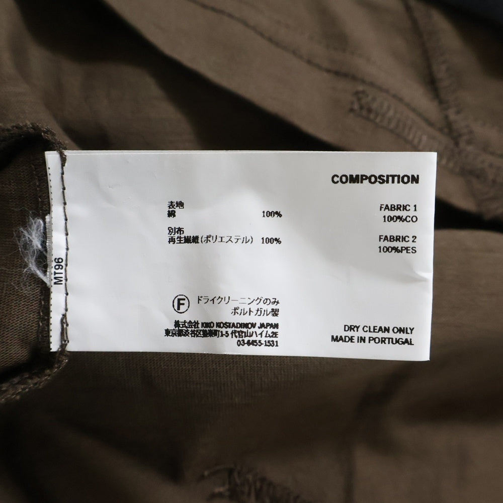 KIKO KOSTADINOV(キココスタディノフ) 25SS INEX HOODED TOP イネックス フーデッド トップ レイヤード 斜めボタン プルオーバーパーカー ブラック/ブラウン 00182025