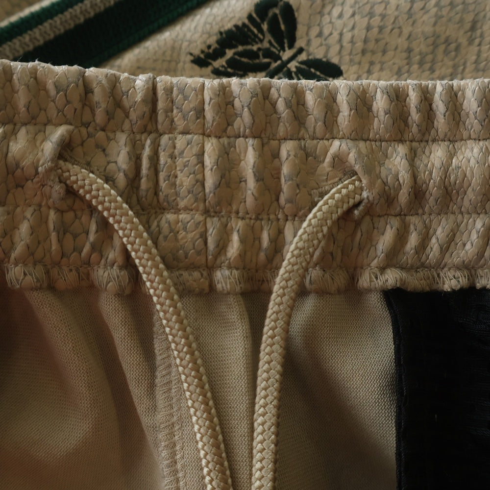 Needles(ニードルス) NARROW TRACK PANT SYNTHETIC LEATHER ナロー シンセティックレザー トラックパンツ ベージュ GL223
