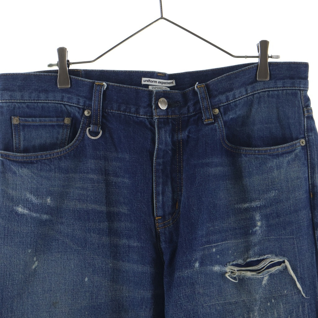 UNIFORM EXPERIMENT(ユニフォームエクスペリメント) 25AW DAMAGED DENIM TAPERED-FIT JEANS テーパードフィット ジップフライダメージデニムパンツ インディゴ UE-252055