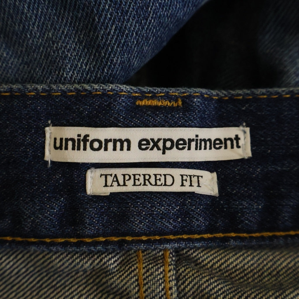 UNIFORM EXPERIMENT(ユニフォームエクスペリメント) 25AW DAMAGED DENIM TAPERED-FIT JEANS テーパードフィット ジップフライダメージデニムパンツ インディゴ UE-252055